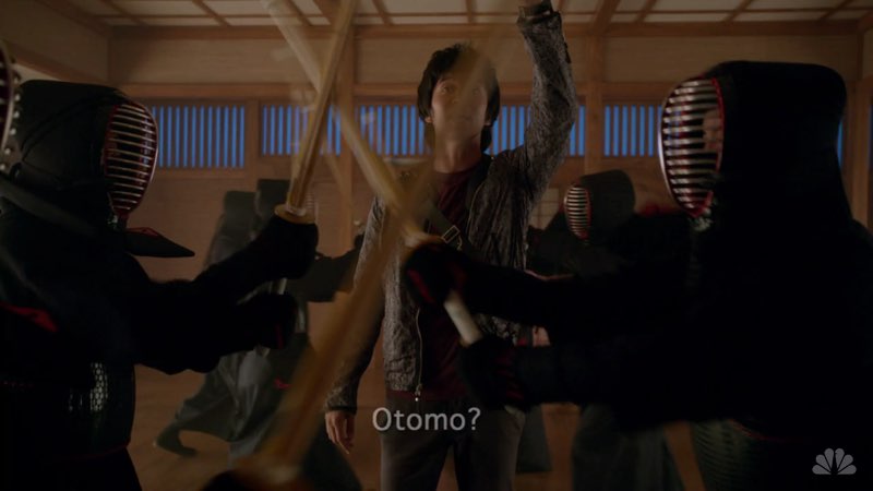 Ren is in a dojo with martial artists training in front of him, blocking his way. He calls out, reaching out with his hand as the word "Otomo?" fades, falling down the screen.