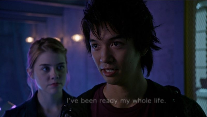 Ren is staring with a confident smile on his face as open captions appear in a bright white font, "I've been ready my whole life," fading out.