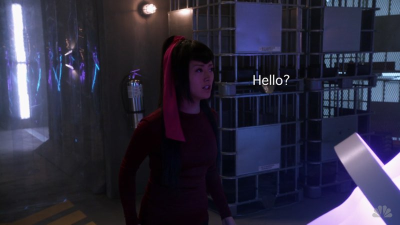 Alone in a room, Miko is looking around. Open subtitles that say “Hello?” appear to her right.