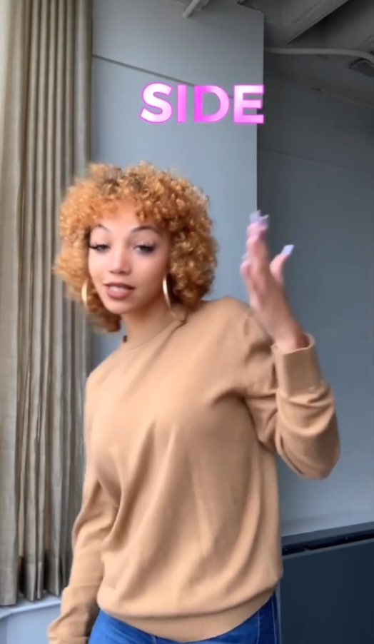 Justina Miles signs the word, "side." Above her are captions for the word "side." The word is pink and glowing.