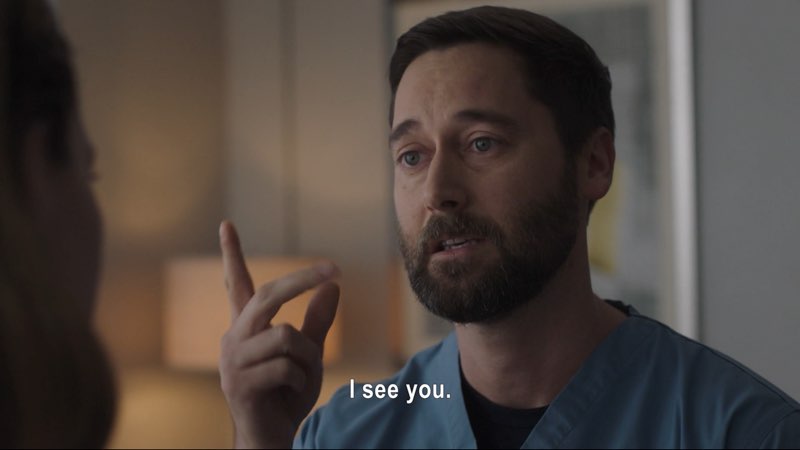 Max, in his hospital scrubs, looks directly at Elizabeth as he signs, “See.” Subtitles at the bottom say, "I see you."
