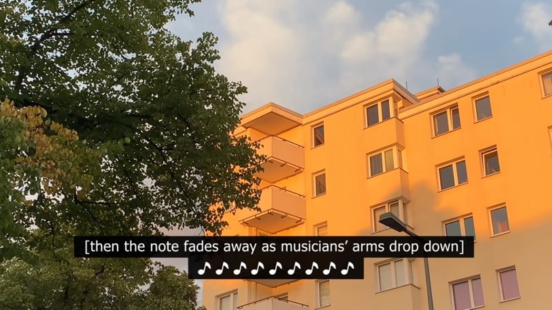 An apartment building is shown against a blue sky next to a tree. Captions at the bottom of the screen read "[then the note fades away as musicians' arms drop down]." The second line of captions shows nine musical notes in a row.