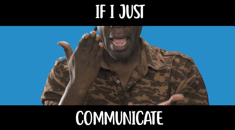 Wawa, in front of a blue background, faces the camera as he signs. White text appears above his face and below his hands on black strips. The text reads, "If I just communicate."