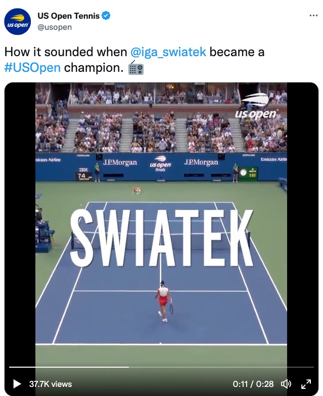 A tweet by US Open Tennis. The tweet reads, "How it sounded when @iga_swiatek became a #US Open champion." The tweet ends with an emoji of a radio. The tweet includes a video of Swiatek and Jabeur playing on a tennis court in the third set with Swiatek leading 6 games to 5. This image shows a moment in the video with extra large open captions over the middle of the court. The captions read, "Swiatek."
